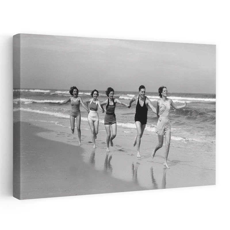 Années 1930, quatre femmes et un homme qui courent sur la plage se tenant la main, H 40 po x l 60 po
