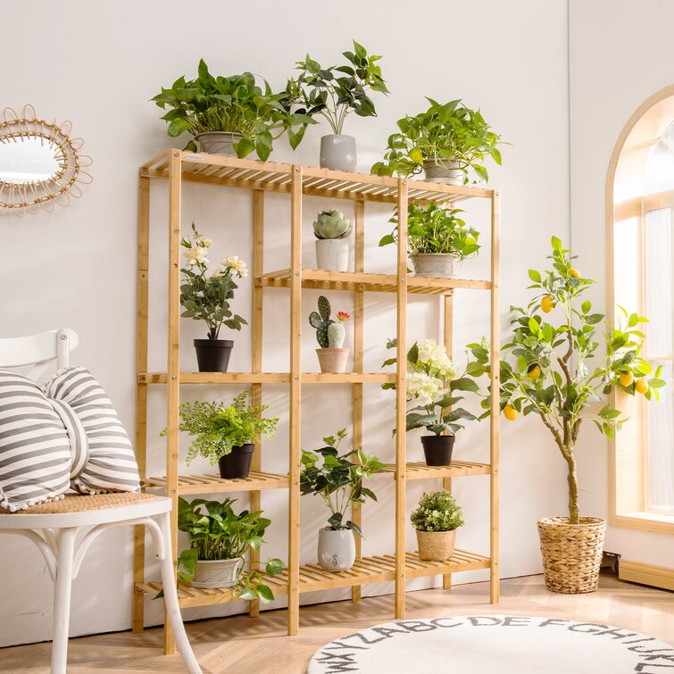 Premium Photo  Wooden shelving unit with interior accessories and  houseplants on white wall
