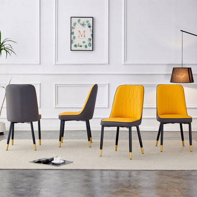 Une chaise de salle à manger moderne avec un dossier en simili-cuir bicolore gris foncé orange et des pieds en métal