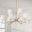 32" W x 9.25" H 9-Light Two-Tier Chandelier in Matte Brass with Clear Acrylic Accents and Cylindrical White Fabric Shades