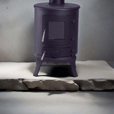 Small cylindrical cast iron wood-burning fireplace