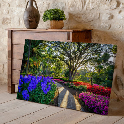 Canvas A Vibrant Enchanting Garden Scene Featuring A Winding Stone Pathway Wall Art Leading Through A Lush Tropical Landscape The Canvas Wall Art