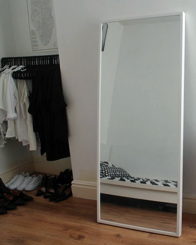 A Modern Monochrome Bedroom with Leaner Mirror