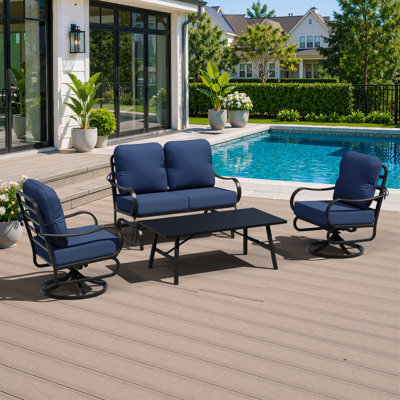 Ensemble de conversation de patio 4 pièces avec causeuse, chaises pivotantes, table basse et coussins en oléfine bleue