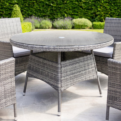 Nohemi 4 - Person Wicker Patio Dining Set with Round Table , Cushions Included
