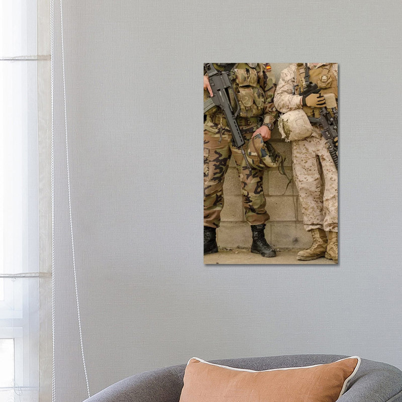 A Spanish Marine And A US Marine Relax Against A Wall by Stocktrek Images - Wrapped Canvas Print