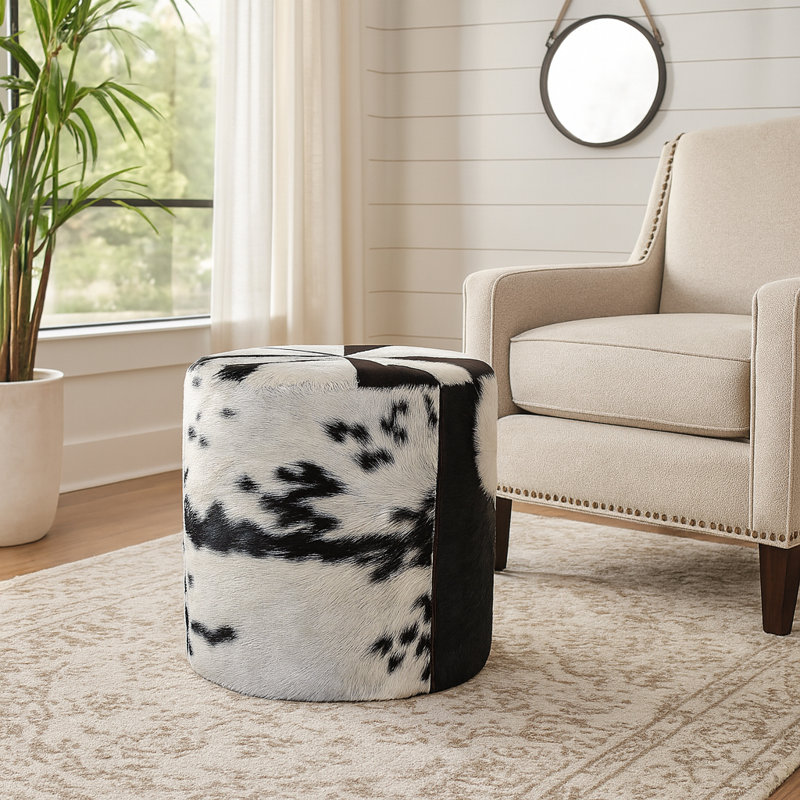 Round Leather Ottoman with Cow Print Design - Luxury Ottoman Pouf Footstool for Living Room and Extra Seating - Perfect Ottoman Accent for Footrest, Coffee Table, or House Decor - 18", Black/White