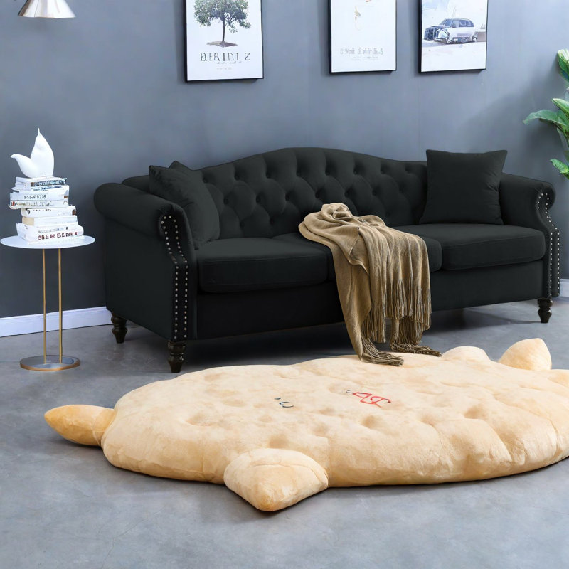 Élégant canapé Chesterfield en velours noir, design classique pour le salon
