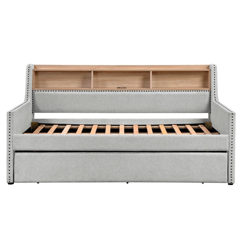 Lit de jour simple moderne gris avec lit gigogne escamotable, côté bibliothèque et charge intégrée, détails cloutés. Structure de lit en bois d'ingénierie, aucun sommier requis, pour les espaces invités