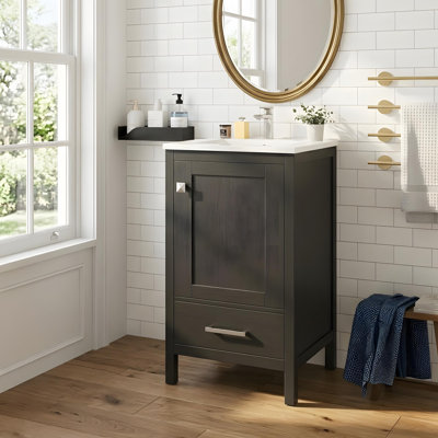 Bathroom vanity with a ceramic sink, compartmentalized drawers, soft-close doors, and a cabinet shelf
