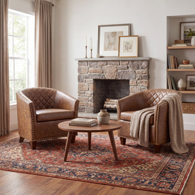 Fauteuil demi-tonneau en cuir moderne avec dossier capitonné à losanges et garniture cloutée