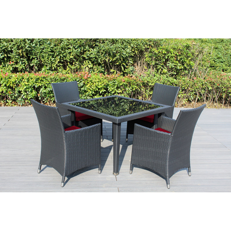 Lumini 4 - Person Wicker Patio Dining Set with Square Table , Cushions Included, Canvas Jockey Red Sunbrella® Canvas