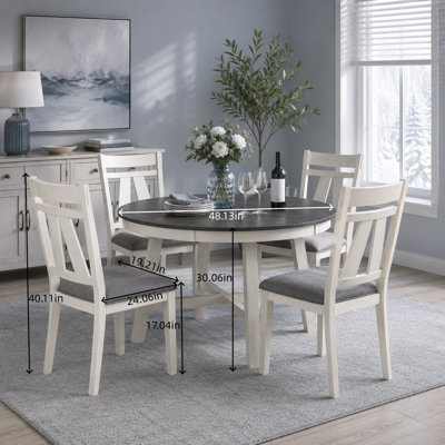 This 5-Piece Dining Set Includes A Round Table And Four Side Chairs. It Features Grey Fabric Cushions And A Wooden Tabletop With Sleek White Linear De