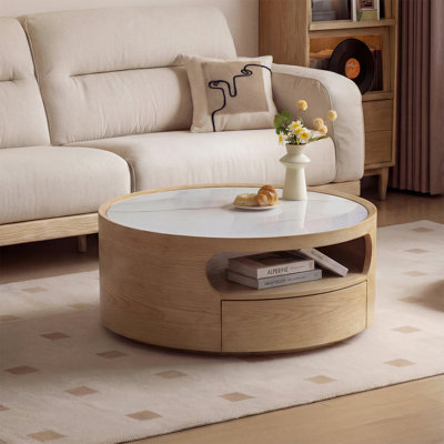 Cette table basse ronde présente un design simple mais élégant, ce qui en fait un choix idéal pour votre salon. Fabriqué en pierre frittée durable et résistante à la chaleur et doté de tiroirs de rangement, il ajoute une touche classique à votre espace.