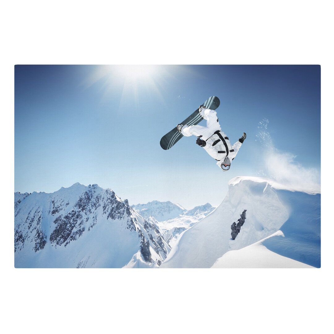 Leinwandbild Fliegender Snowboarder