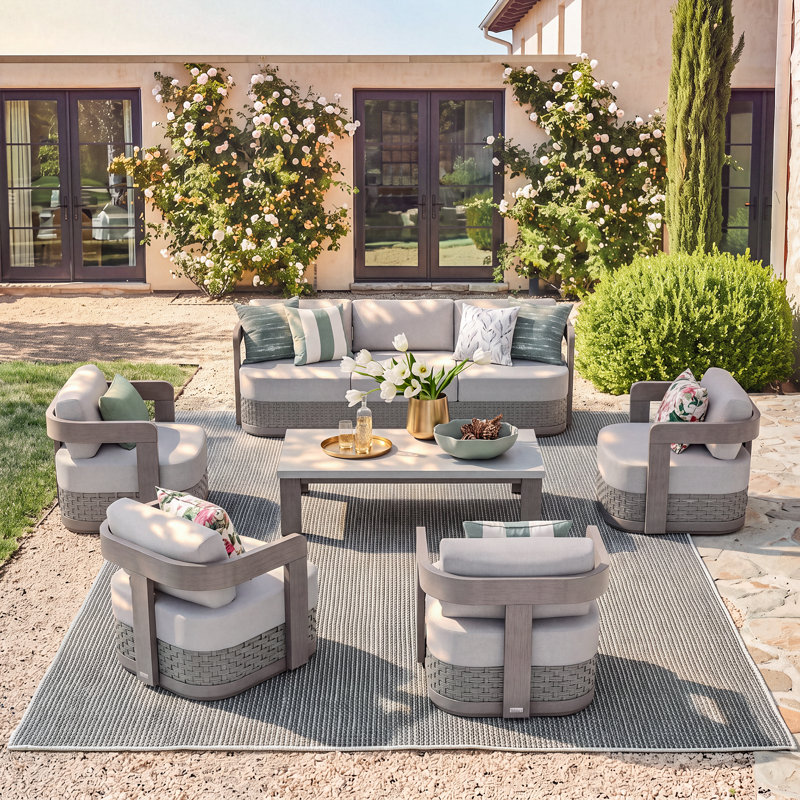 Ensemble de conversation Manarola Patio en aluminium et résine tressée PE avec coussins Sunbrella® et table en béton pour 7 personnes