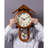 Vintage solid wood wall clock with a roof-shaped top and a metal pendulum