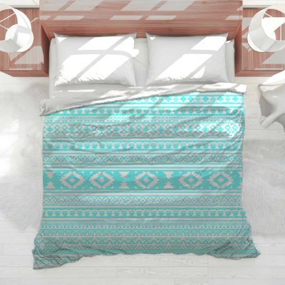 Édredon turquoise à motifs géométriques