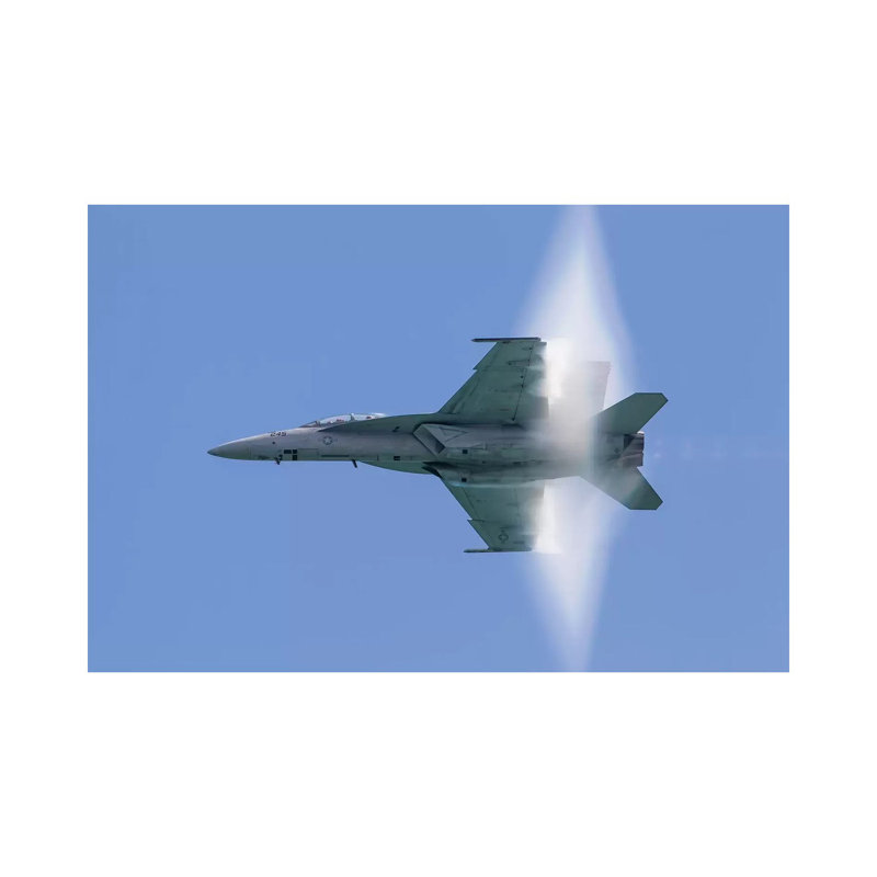 A US Navy F/A-18F Super Hornet Flies By At High Transonic Speed by Rob Edgcumbe - Wrapped Canvas Print