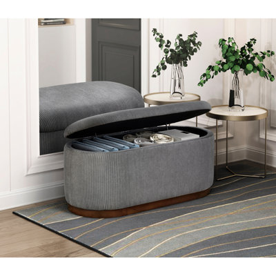 Banc de rangement en velours côtelé gris moderne avec structure et pieds en noyer rembourrés de mousse
