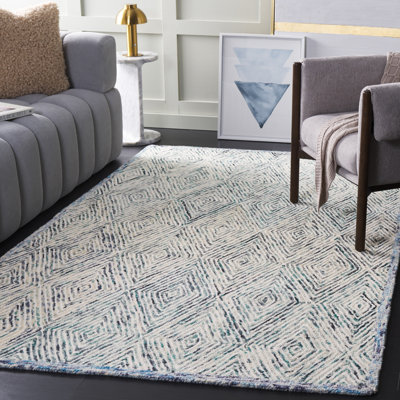 Tapis géométrique bleu / ivoire en laine touffetée à la main de la personne