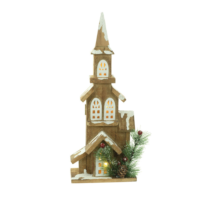 Église éclairée de table brune recouverte de neige