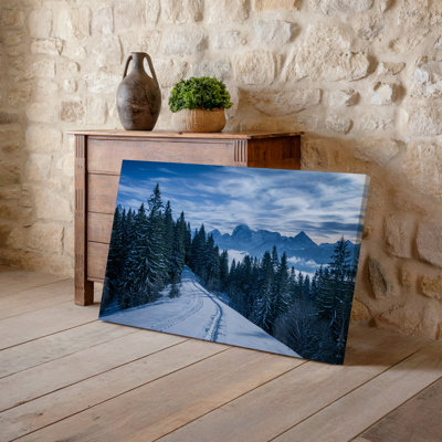 Canvas A Serene Winter Landscape Featuring A Winding Snow Covered Path Wall Art Leading Through A Dense Forest Of Tall Evergreen Trees Canvas Wall Art