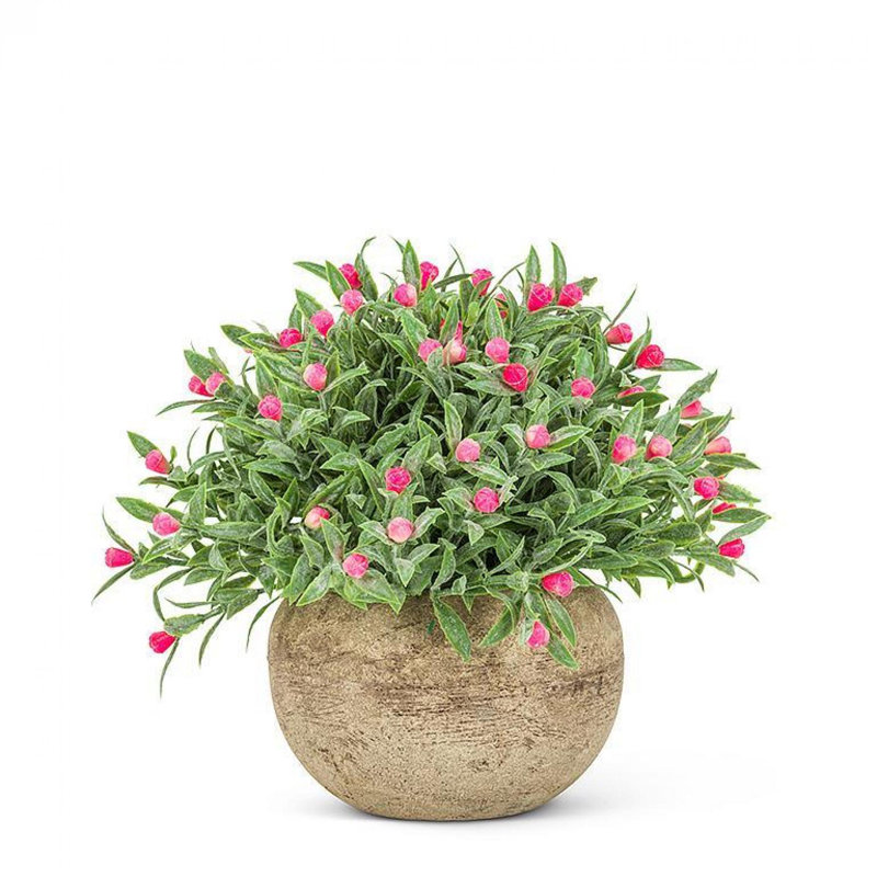 Fleur rose dans un pot de fleurs artificielles