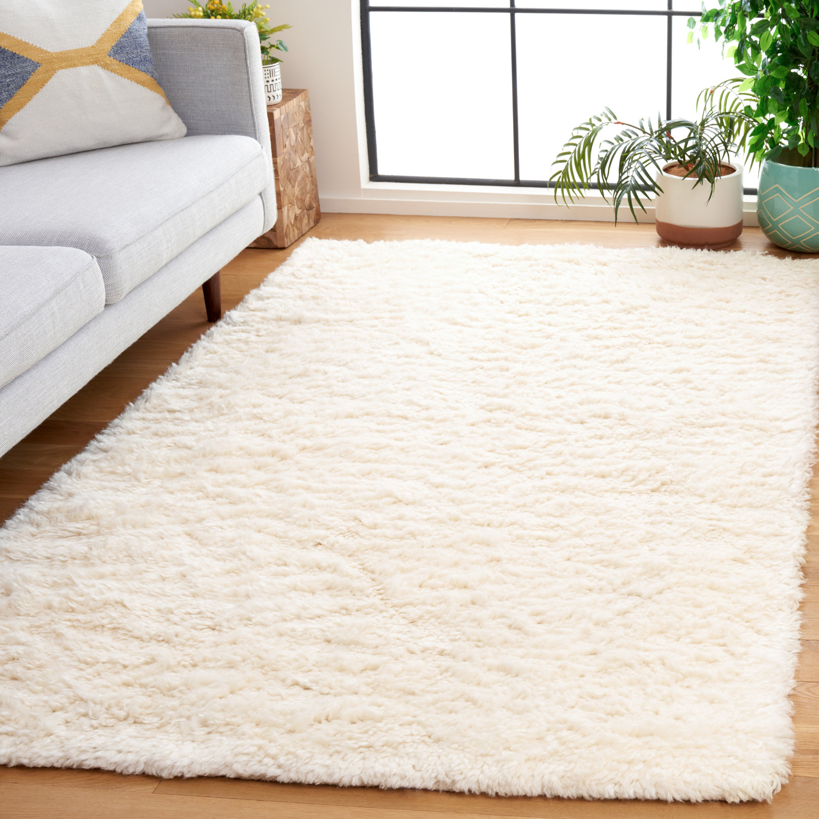 Abriel Ivory Solid Hand-Woven Wool Rug, Rectangle 5' x 8'