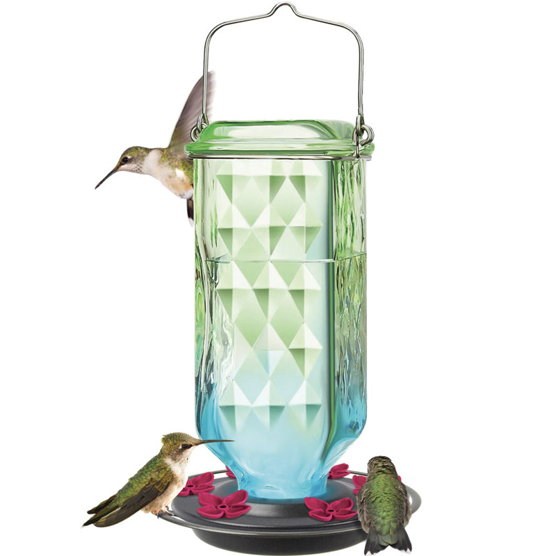 Colonne en verre antique colibri mangeoire ombre