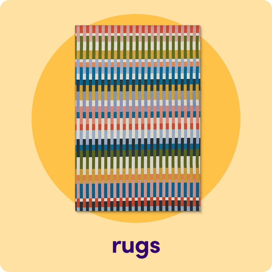 An outdoor rug featuring a vibrant, multi-colored vertical stripe pattern on a yellow circular background.