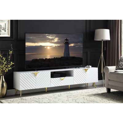 Meuble télé blanc élégant, poids du colis : 51 kg, 2 étagères de rangement, finition laquée brillante, pattes de support, 4 portes.
