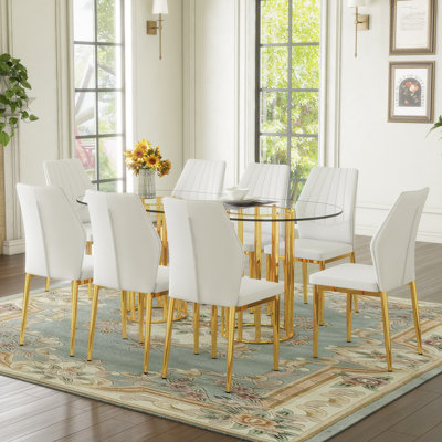 Ensemble de table et de chaises Table de salle à manger ovale en verre trempé de 71 pouces de style luxueux à double colonne dorée. Jumelé avec 8 chaises en polyuréthane blanc avec des pieds dorés. Hauteur de 37 pouces: dossier ergonomique en polyuréthane.