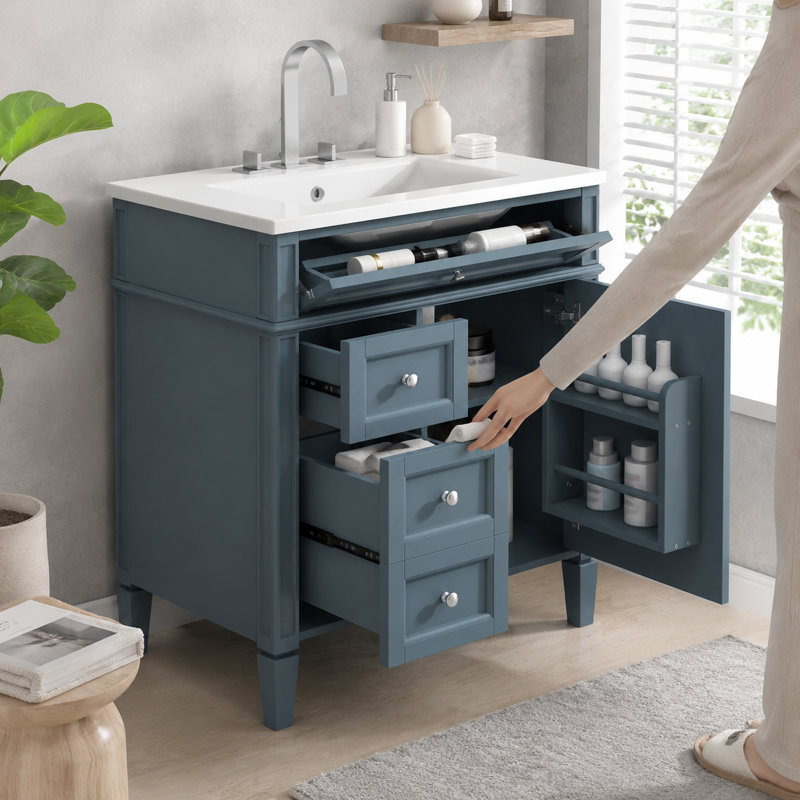 Meuble-lavabo autoportant bleu sarcelle discret avec robinet chromé et lavabo en céramique blanche