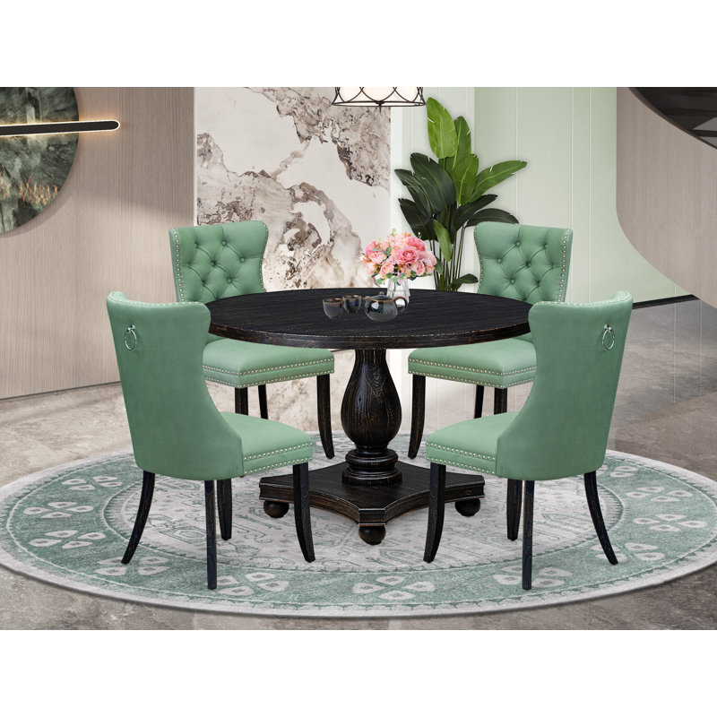 L'ensemble de salle à manger 5 pièces comprend une table ronde de 48 po avec piédestal et 4 chaises rembourrées en similicuir vert saule, noir sablé