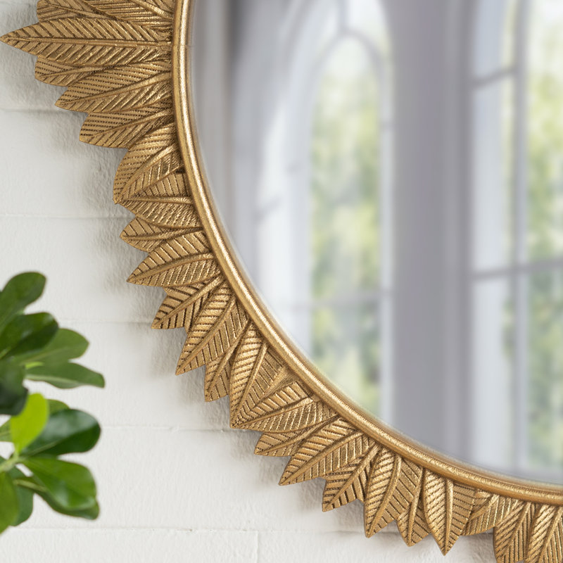 Miroir mural rond avec cadre doré orné