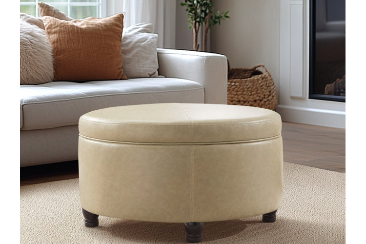 modern drum shaped ottoman with internal storage in a modern style living room with beige area rug and white sofa