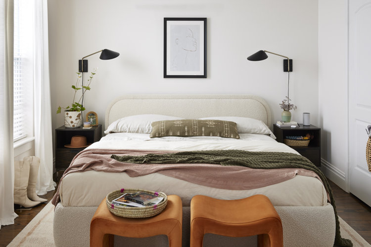 how to style a bed; modern bedroom with a boucle bed, neutral bedding, and two black wall sconces