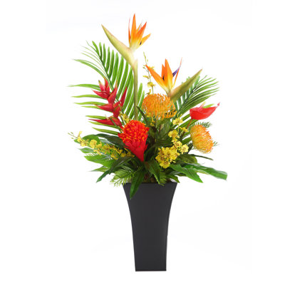 Assortiment de fleurs tropicales dans un pot de fleurs carré en métal noir évasé