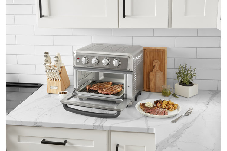 silver stainless steel toaster oven on a kitchen counter with a marble top