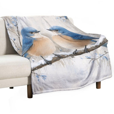 Bluebirds perché sur une luxueuse couverture en flanelle Snowy Branch