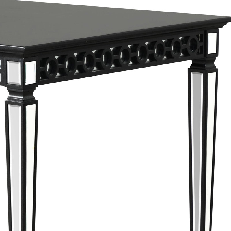 Élégante table de salle à manger noire avec tablier géométrique et plateau rectangulaire en bois avec décoration en miroir