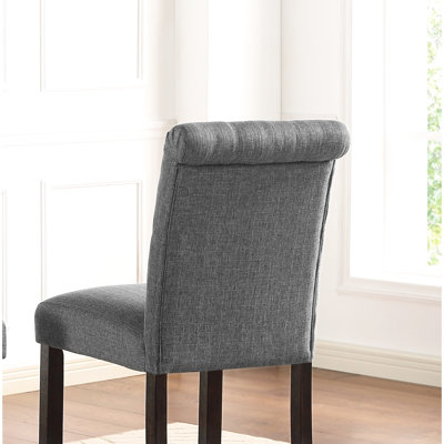 Grey Counter Height Stool  2 . Solid Wood Build With Stylish Details. Cushioned Seats And Backs For Optimal Comfort. Dark Wooden Legs. Elegantly Curved High-Back Chairs. 23" W X 19" D 41.07" H. Seat