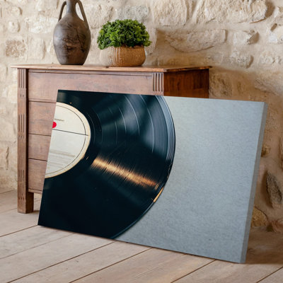 Canvas A Close Up View Of A Vintage Black Vinyl Record Wall Art Positioned At An Angle Against A Smooth Light Colored Background For Canvas Wall Art