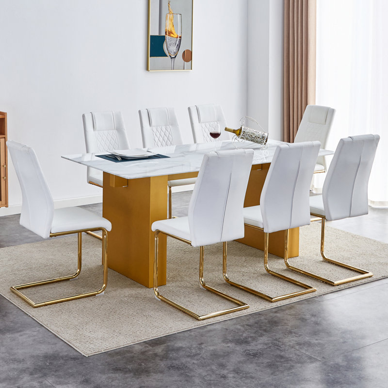 Ensemble de table et de chaises rectangulaire large avec plateau en verre à motif de pouces et grands pieds de table en bois aggloméré avec chaises avec sièges rembourrés en similicuir et pieds en métal