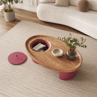 45.5-inch oval wooden storage coffee table with walnut top and red legs. A mid-century modern living room centerpiece, suitable for spacious farmhouse-style interiors.