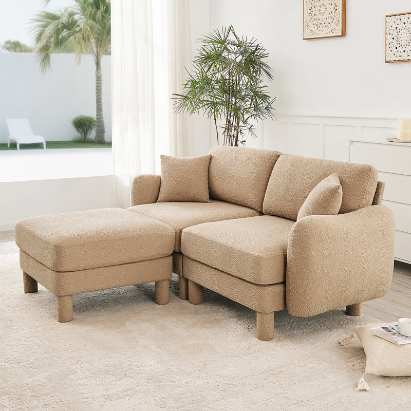 Canapé-lit à 2 places en tissu Boucle avec accoudoirs en forme de coquillage distinctif, repose-pieds amovible et pieds cylindriques pour une assise confortable