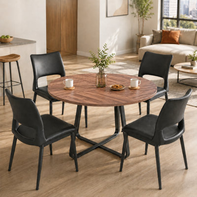 43.3-inch walnut colored dining table with black metal cross base and four black PU leather chairs, modern four person five piece set circular dining