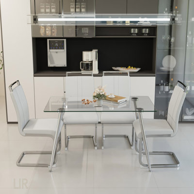 Ensemble de table de salle à manger moderne en verre de 51 pouces avec 4 chaises sans accoudoirs en polyuréthane et des pieds plaqués argent pour une cuisine et une salle à manger élégantes