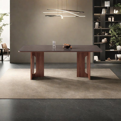 Une table de salle à manger en granit avec des pieds en bois de frêne